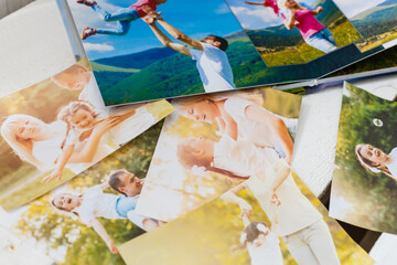 Family photos archive saved in brightly designed photo book; bright summer memories placed in the...