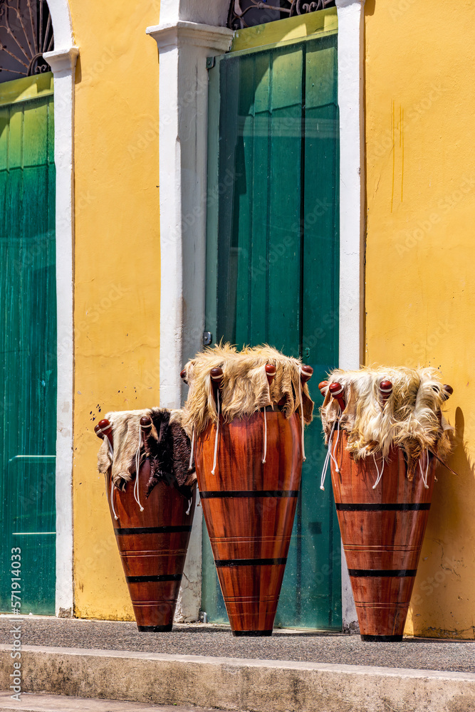 Wall mural Decorated ethnic drums also called atabaques on the streets of Pelourinho district, the historic center of the city of Salvador in Bahia