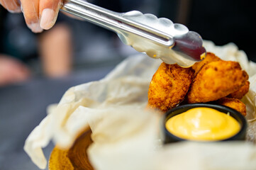 woman chef cooking Chicken Nuggets with French Fries and sauce on kitchen