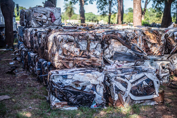 Recycled Cars. Scrap Metal Pressed Into Buckets For Recycling.