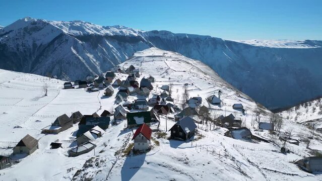 Aerial drone view of mountain village during winter. Snow white landscape and mountaineer lifestyle. 