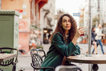 Woman tourist drinking traditional Turkish tea in outdoor cafe