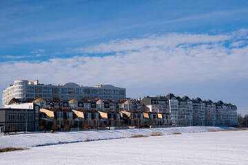 Modern housing in Ukraine on the river bank. Winter cityscape in sunny weather