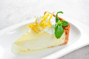 Dessert. Cheesecake with ice cream and honey. On a white plate. On a gray stone background. Restaurant menu.