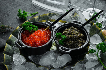 Premium caviar of high quality. Set of red and black caviar in bowls. Top view.