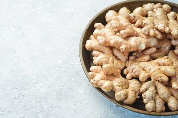 Ginger root in a box. Foods containing vitamin C. Free space for text on a stone background.
