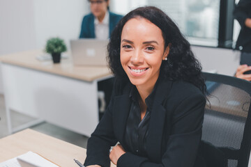 Fototapeta premium Portrait smiling cheerful beautiful attractive young businesswoman 30s wearing shirt sitting working typing on laptop pc computer searching and studying business ideas on a laptop screen on-line.