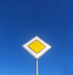 blank yellow sign, main road sign, yellow road sign on the background of the blue sky