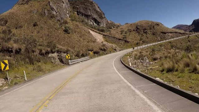 Andean highway that shows beautiful paramo landscapes, with wide shoulders to drive comfortably on a sunny day with little cloudiness
