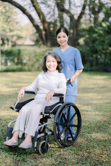 Fototapeta premium Photo of positive doctor and patient on wheelchair outdoor.