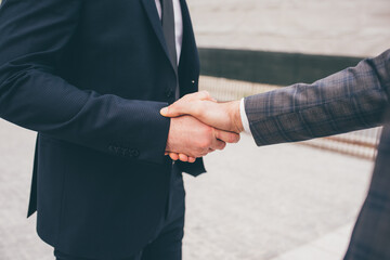 Close up professional businessmen shake hand with partner to celebration partnership and business deal