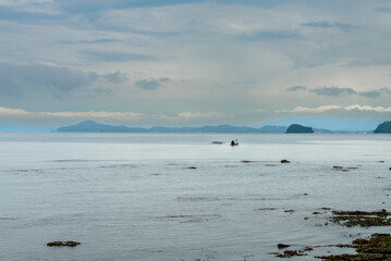 Boat in a tropical country. This photo captures the essence of the Philippines, with a traditional wooden boat bobbing on crystal-clear turquoise waters, surrounded by lush green tropical foliage. 
