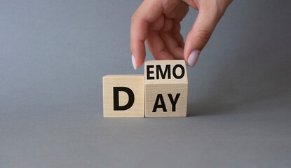 Demo Day symbol. Businessman hand turns wooden cubes with concept words Demo Day. Beautiful grey background. Business and Demo day concept. Copy space