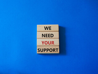 We need your support symbol. Wooden blocks with words We need your support. Beautiful blue background. Business and We need your support concept. Copy space.