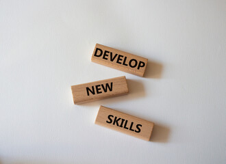 Develop New skills symbol. Concept word Develop New skills on wooden blocks. Beautiful white background. Business and Develop New skills concept. Copy space