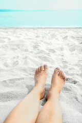 beautiful legs in the sand of the sea greece background