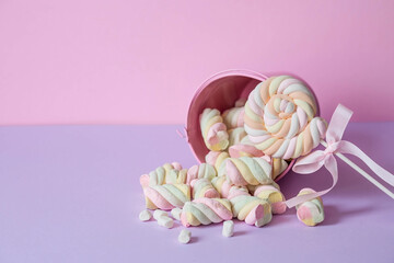 Marshmallows. Chewing candy close-up on a pink background. Dessert of sweet dishes in a pink bucket. Pastel colors. A copy of the text space.