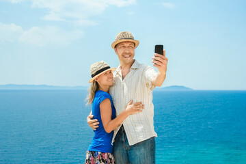 A happy couple selfie at sea on travel