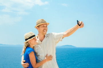 A happy couple selfie at sea on travel