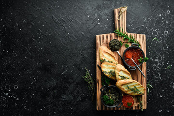 Caviar. Black and red premium caviar and toast bread for making sandwiches. On a wooden board. Rustic style. Top view.
