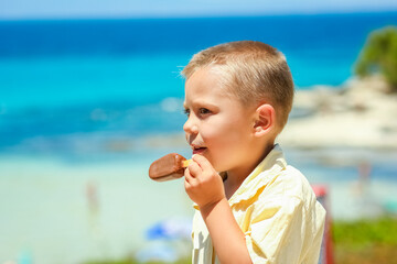 A Happy child boy with ice cream by the sea in nature in the park journey