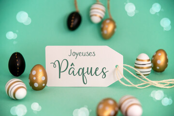 Fototapeta na wymiar Golden Easter Egg Decoration. Label With Joyeuses Paques Means Happy Easter
