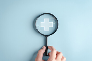 Health insurance concept. Hand people holding Magnifier focus to plus symbol and healthcare medical...
