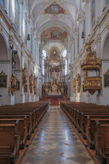Fototapeta na wymiar Magnificent opulent splendid Bavarian baroque church cathedral basilica interiors with stucco, murals, altar, Pilars, ceiling paintings, gold, wood domes nave 