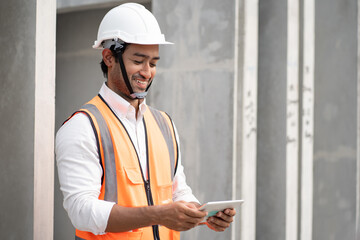 Happy Asia engineer man working with tablet at precast factory