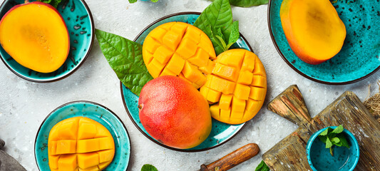 Fresh sliced mangoes. Famous Alphonso mango. Top view on a rustic background. Copy space.