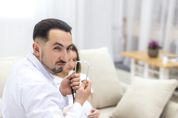 Cropped photo of doctor with stethoscope going to exam the pregnant woman.