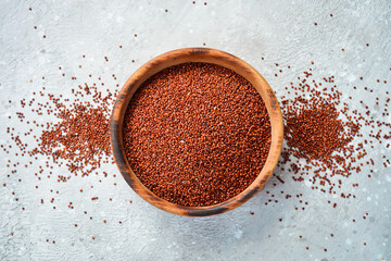 Black quinoa in a wooden bowl. On a stone background. Top view.