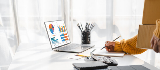 Asian elderly older female mature woman fashion designer sme business owner with product package box at warehouse, merchant seller checking customer address order confirming parcel delivery.