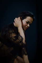 Portrait of a beautiful young Brazilian woman in underwear fixing her hair with her hand