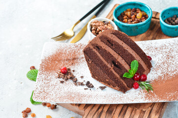 Dessert. Chocolate cake. On a white plate. On a gray stone background. Restaurant menu.