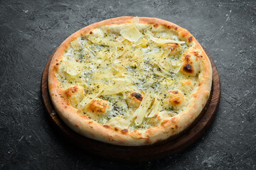 Traditional Italian pizza with cheese. Home delivery of food. On a black stone background.