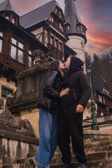 a girl and a guy are kissing against the backdrop of a castle in Romania Brasov, Romania, Europe