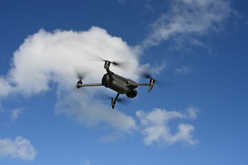 Fototapeta na wymiar Drone in flight - blue sky.