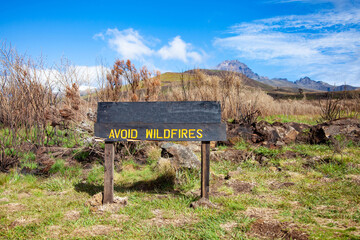 Wooden sign Avoid wildfires on the path in the mountains.