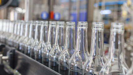 Closeup view of modern vodka bottling line.