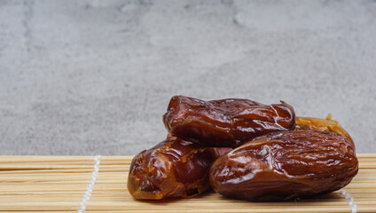 Kurma or dattes palm fruit in bamboo mat is snack healthy, selective focus