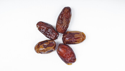 Flat lay concept - Dried sliced date fruit on white background.