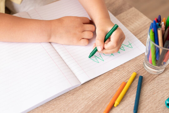 boy writing in a notepad