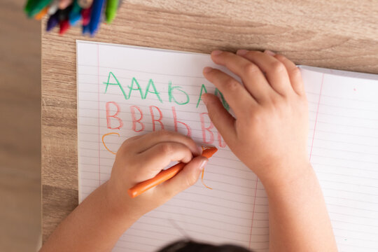 boy writing in a notepad