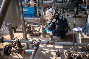Male worker inspection at steel long pipes and pipe elbow in station oil factory during refinery...