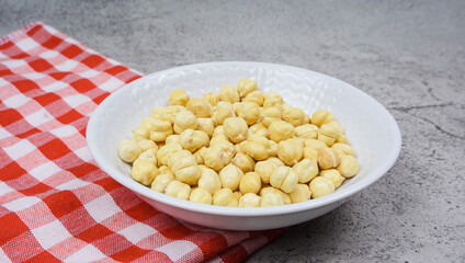A bowl of chickpeas on cement texture backgound