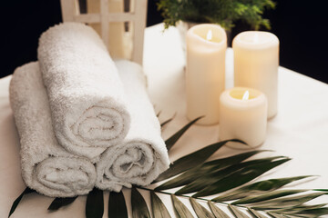 Plakat Spa still life with aromatic candles,oils and towel. Dark background