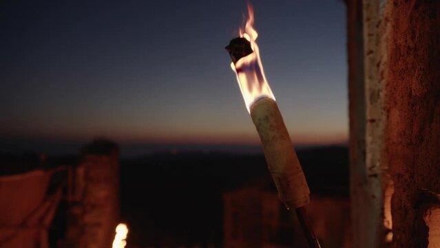 Flame torch light a street of a medieval city in the night