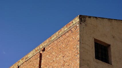 brick building roof against the sky