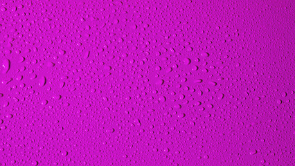 Water drops on a purple plastic. Copy Space